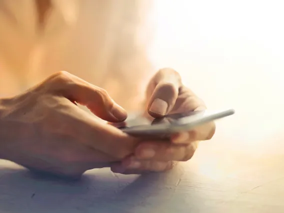 close up of hands dialing a phone