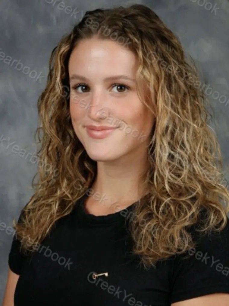 headshot of a person with a grey background